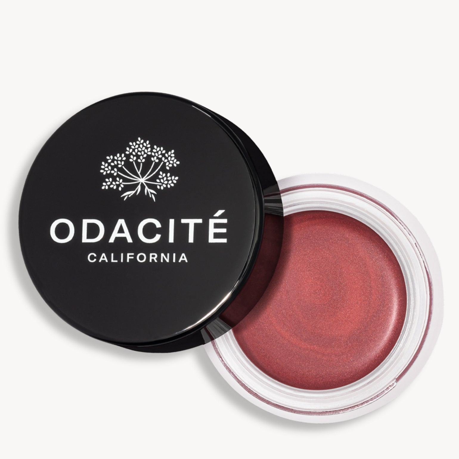 Pot ouvert de la teinte sienna rose du Baume teinté SPF50 Odacité avec le capuchon